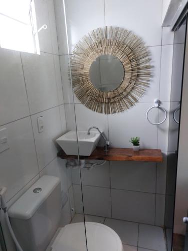 a bathroom with a toilet and a mirror at Pousada Rocas Beach in Pôrto de Pedras