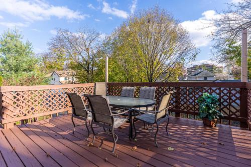 a patio with a table and chairs on a wooden deck at H3 Studio Bedroom Downtown Stamford in Stamford