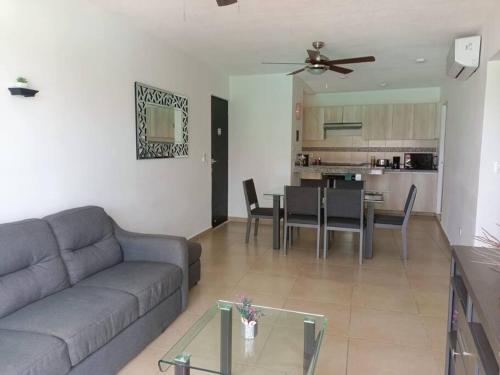 a living room with a couch and a table at Beautiful condo in Cancun! Dreams Lagoon in Cancún