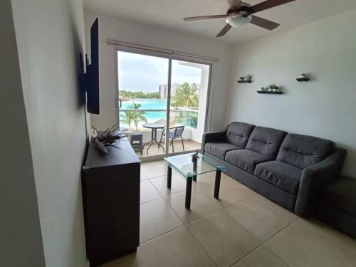 a living room with a couch and a table at Beautiful condo in Cancun! Dreams Lagoon in Cancún