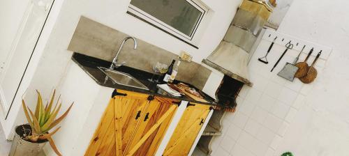 a kitchen with a sink and a wooden counter at Villa Yandre Garden House - Ayamonte in Ayamonte