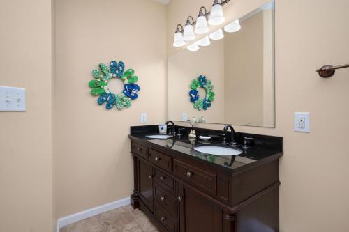 a bathroom with a sink and a mirror at This Is It by Oak Island Accommodations in Oak Island