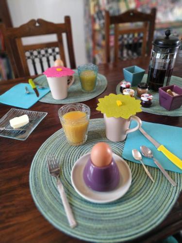 a table with plates and utensils and eggs on it at L'eau berges in Chandolas
