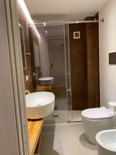 a bathroom with a toilet and a sink and a shower at Egregia Dimora in Catania