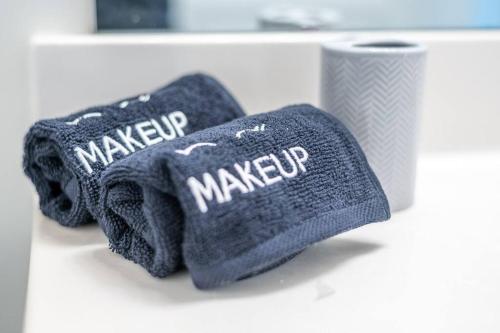 two knitted mittens sitting on a counter next to a cup at Duke 10 Min Away 3 Bedroom in Durham