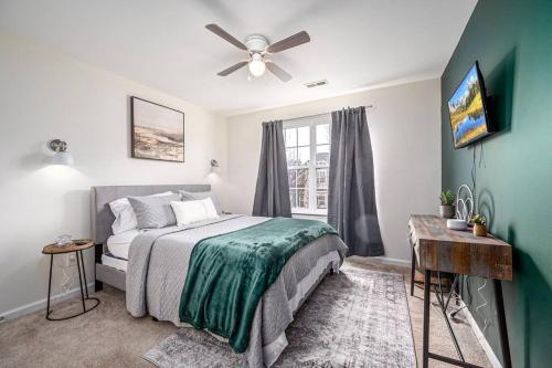 a bedroom with a bed and a ceiling fan at Duke 10 Min Away 3 Bedroom in Durham