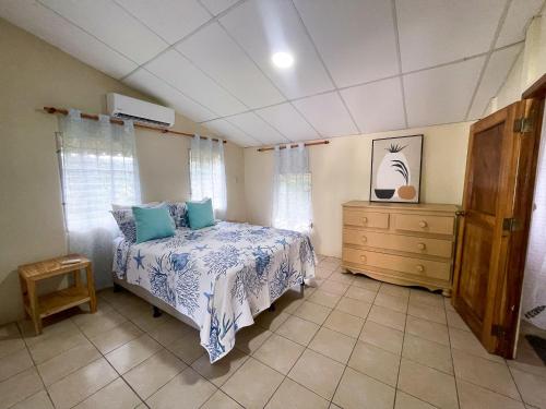 a bedroom with a bed and a dresser at Casa De Playa El Encanto in El Porvenir