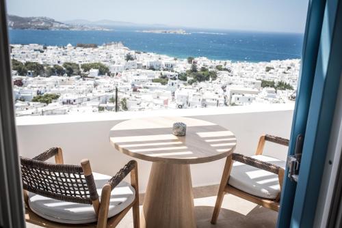a table and chairs with a view of the city at Νumi Boutique Hotel in Mýkonos City
