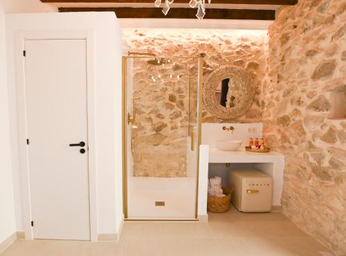 a bathroom with a shower with a glass door at Ca Sana Teulada Moraira, Grupo Terra de Mar, alojamientos con encanto in Moraira