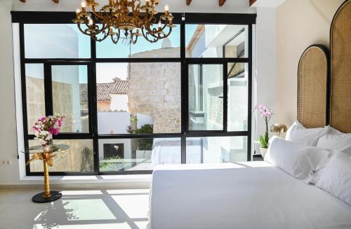 a bedroom with a bed and a large window at Ca Sana Teulada Moraira, Grupo Terra de Mar, alojamientos con encanto in Moraira