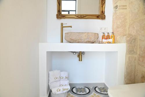 a bathroom with a sink and a mirror at Ca Sana Teulada Moraira, Grupo Terra de Mar, alojamientos con encanto in Moraira