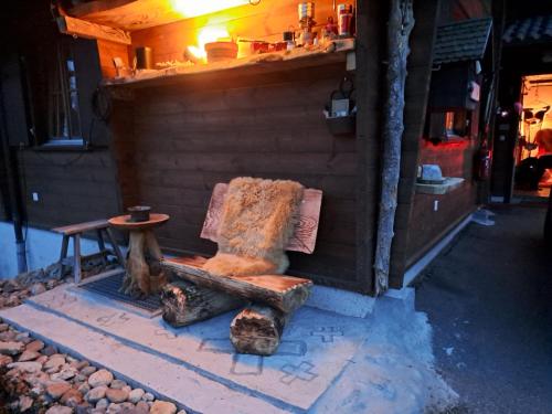 a wooden bench sitting outside of a building at Chalet Chnorz Hosted in Nesslau
