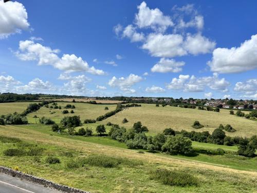 a view of a field with trees and a road at Ground floor flat in Keynsham