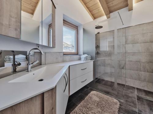 a bathroom with a sink and a shower at Ferienhaus 12 im Feriendorf Kirchdorf in Kirchdorf in Tirol