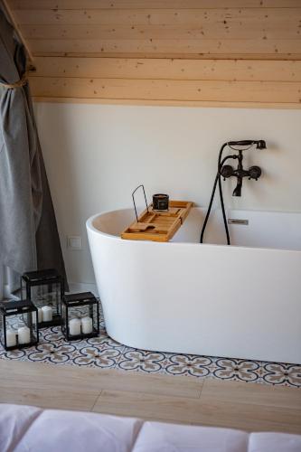a bath tub in a room with candles on the floor at Szurmiejówka in Mieroszyno