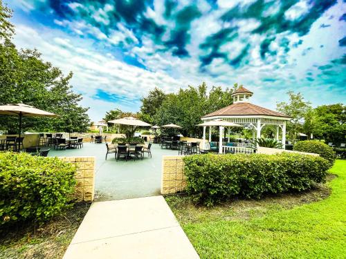 a gazebo with tables and chairs in a park at Holiday Inn - St Augustine - World Golf, an IHG Hotel in St. Augustine