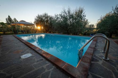 a swimming pool with a metal hand rail next to it at Agriturismo La Casetta del Sole in Villastrada