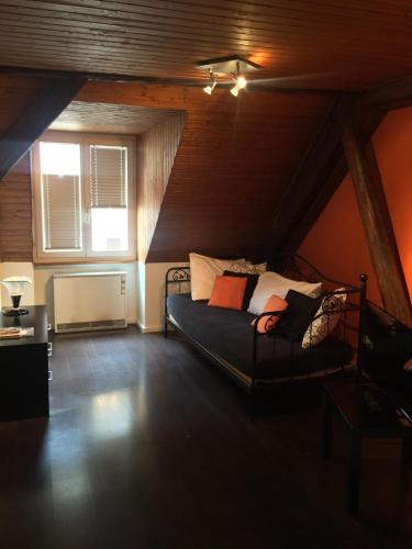 a bedroom with a bed in a attic at Hôtel-Restaurant Le Lion d'Or in Porrentruy