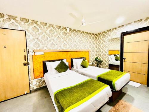 two beds in a hotel room with two beds at Hotel Lake View Airport zone in Hyderabad