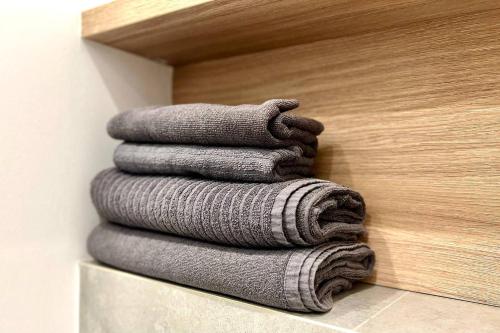 a pile of towels stacked on a shelf in a bathroom at K22 Slawinska 507 Big Family in Warsaw