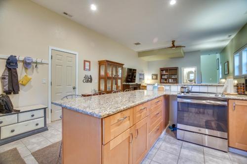 a large kitchen with wooden cabinets and a counter top at Cascade Cabin Hideaway with Views, half Mi to Lake in Cascade