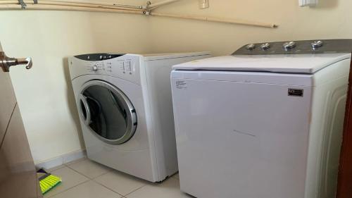 a washing machine and a washer in a laundry room at Encanto Living Two Bedroom Unit by Kivoya in Puerto Peñasco
