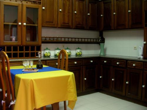 a kitchen with a table with a yellow table cloth at Villa São Paulo in Funchal