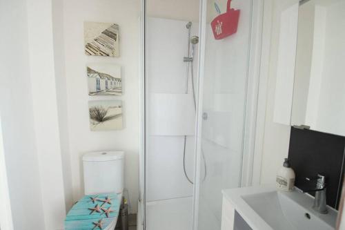a white bathroom with a shower and a toilet at Joli studio à 3 min de la plage in Royan