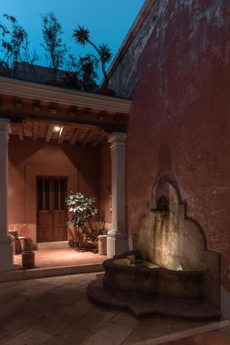 a fountain in the courtyard of a house at Jr-Kiyo Estudios in Oaxaca City