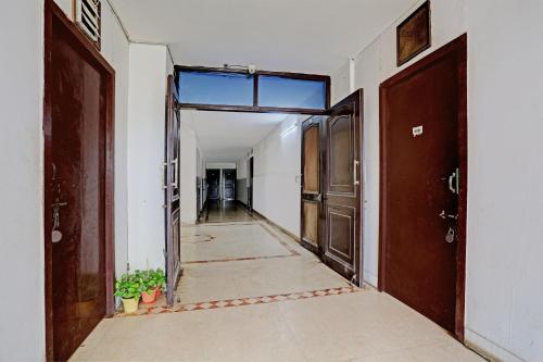 an empty hallway with two doors and a hallway sidx sidx at OYO Flagship Naveen Stay 2 in Gurgaon