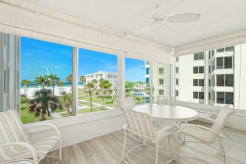 a room with a table and chairs and a large window at Island House Beach Resort 14S in Point O'Rocks