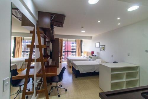 a room with two beds and a staircase in it at Garvey Park Hotel - Apartamento Particular in Brasilia