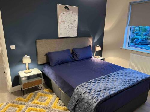 a bedroom with a bed with blue sheets and a window at 3 bed rooms Vip family house in Dublin