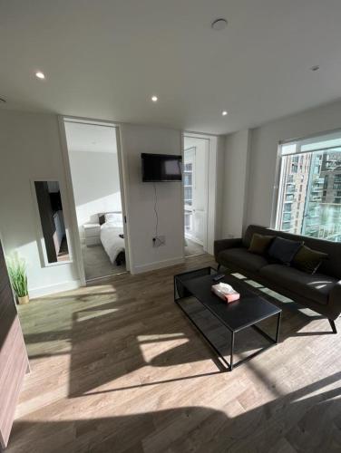 a living room with a couch and a table at Zencityhomes in Barking