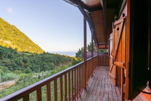 a balcony of a house with a view of the ocean at Villa Fontes 5 in Ponta Delgada