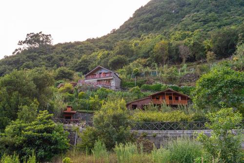 a group of houses on the side of a mountain at Villa Fontes 5 in Ponta Delgada