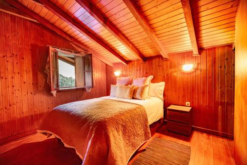 a bedroom with a bed in a wooden room at Villa Fontes 5 in Ponta Delgada