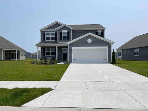 a house with a driveway and a garage at Gorgeous Seaside Paradise - Ultimate Family Getaway! in Ocean View