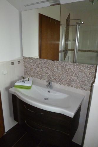 a bathroom with a sink and a mirror at Haus Weinheck in Lebach