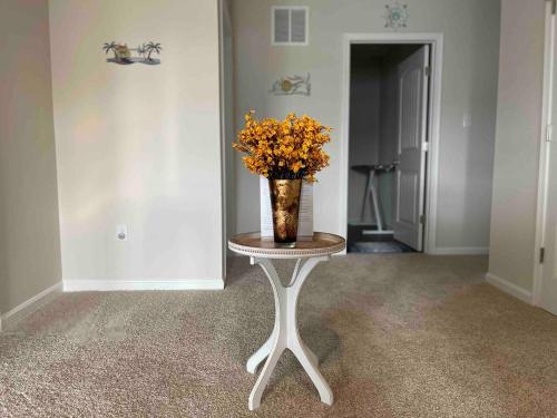 a vase of flowers sitting on a table in a room at Gorgeous Seaside Paradise - Ultimate Family Getaway! in Ocean View