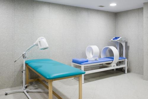 a hospital room with two chairs and a table at Hotel Trojan in Lądek-Zdrój