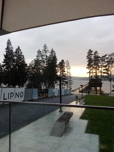 a view of the ocean from a building with a bench at Apartman LEO Nr. 8 Lipno nad Vltavou in Lipno nad Vltavou