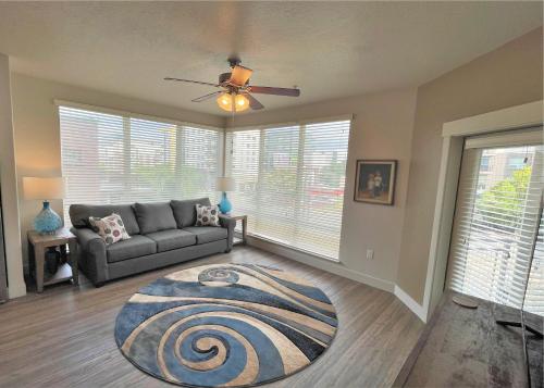 a living room with a couch and a ceiling fan at Luxury Condo in the Best Part of Downtown in Salt Lake City