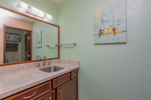a bathroom with a sink and a mirror at Hideaway Haven Suite in Princeville