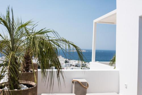 a view of the ocean from the balcony of a house at Νumi Boutique Hotel in Mýkonos City