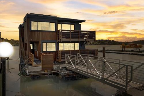 a house sitting on top of a body of water at Floating Condos of Commodore 11 in Mill Valley