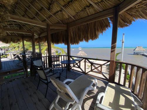 a porch with chairs and a table and the ocean at Captain Morgan's Retreat in San Pedro