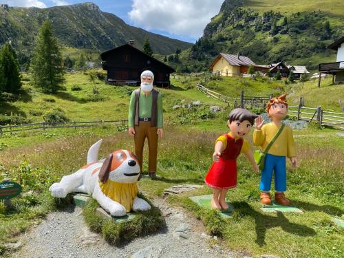 a group of toy figures in a field with a dog at Appartement Rosa in Patergassen