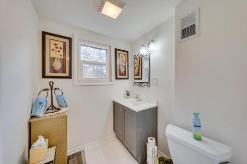 a white bathroom with a sink and a toilet at Powers Lake Home with Patio - 9 Mi to Lake Geneva! in Powers Lake