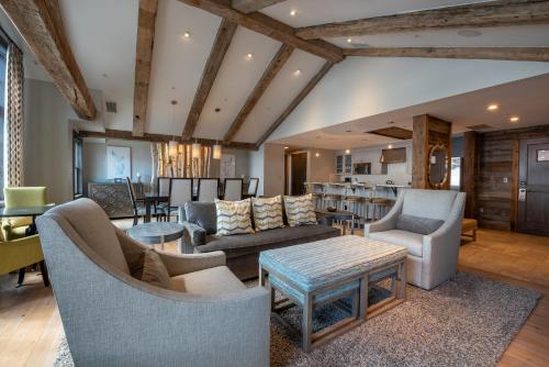 a living room with couches and chairs and a table at The Lodge at Mountaineer Square in Mount Crested Butte
